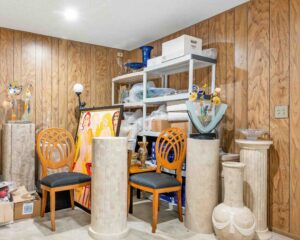 A photo of a cluttered basement prior to a cleanout project.