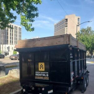 A photo of a dumpster rental that is being used for commercial businesses.